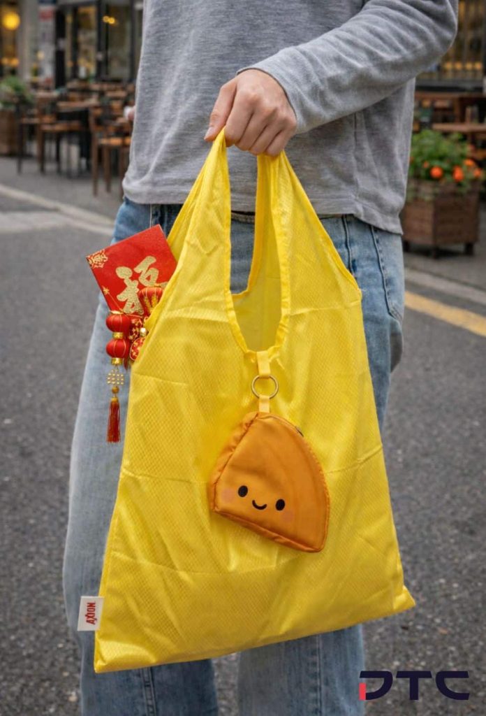 Foldable reusable campaign bag styled in lifestyle setting for Colgate-Palmolive Malaysia festive merchandise