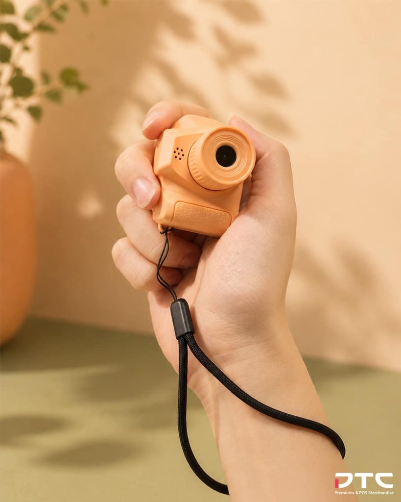Peach-coloured Magnum working keychain camera used as an FMCG gift with purchase