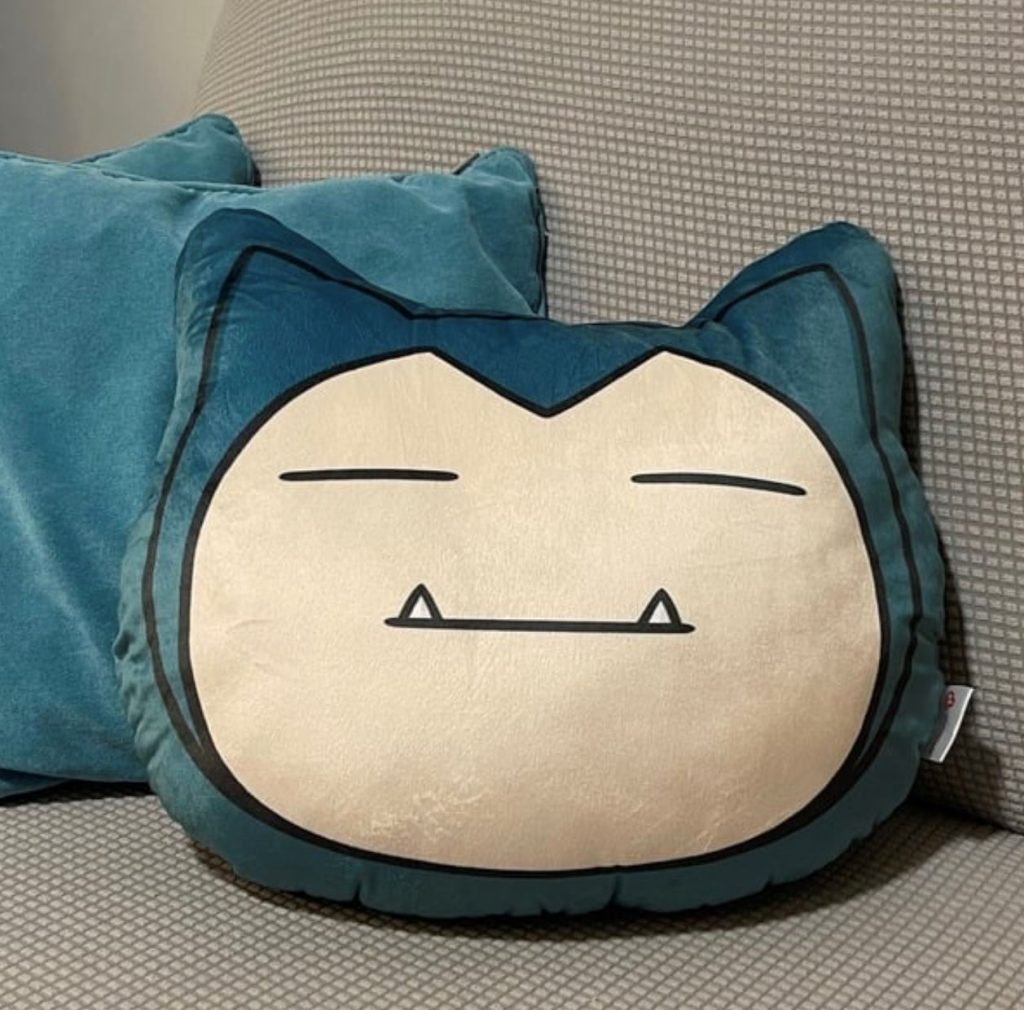 Snorlax cushion on sofa