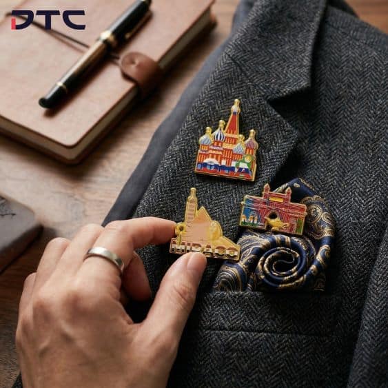 Midea enamel pins inspired by MIRACO regional landmarks worn on coat