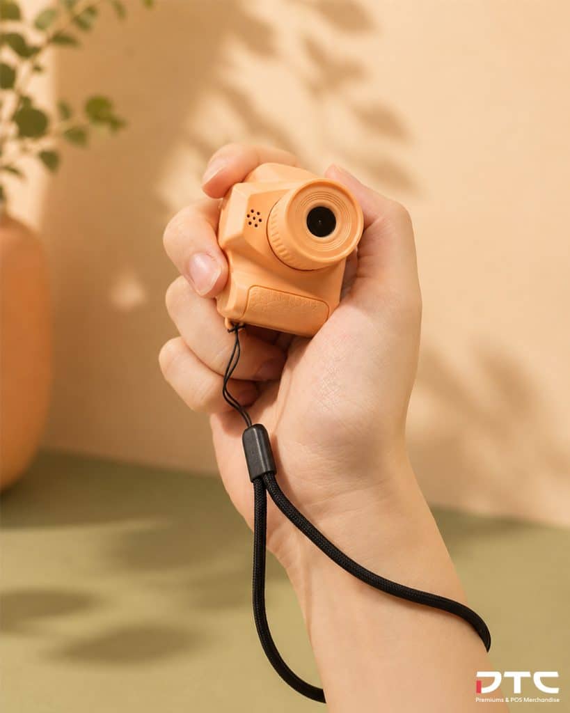 Magnum La Peche branded mini camera keychain in peach pink
