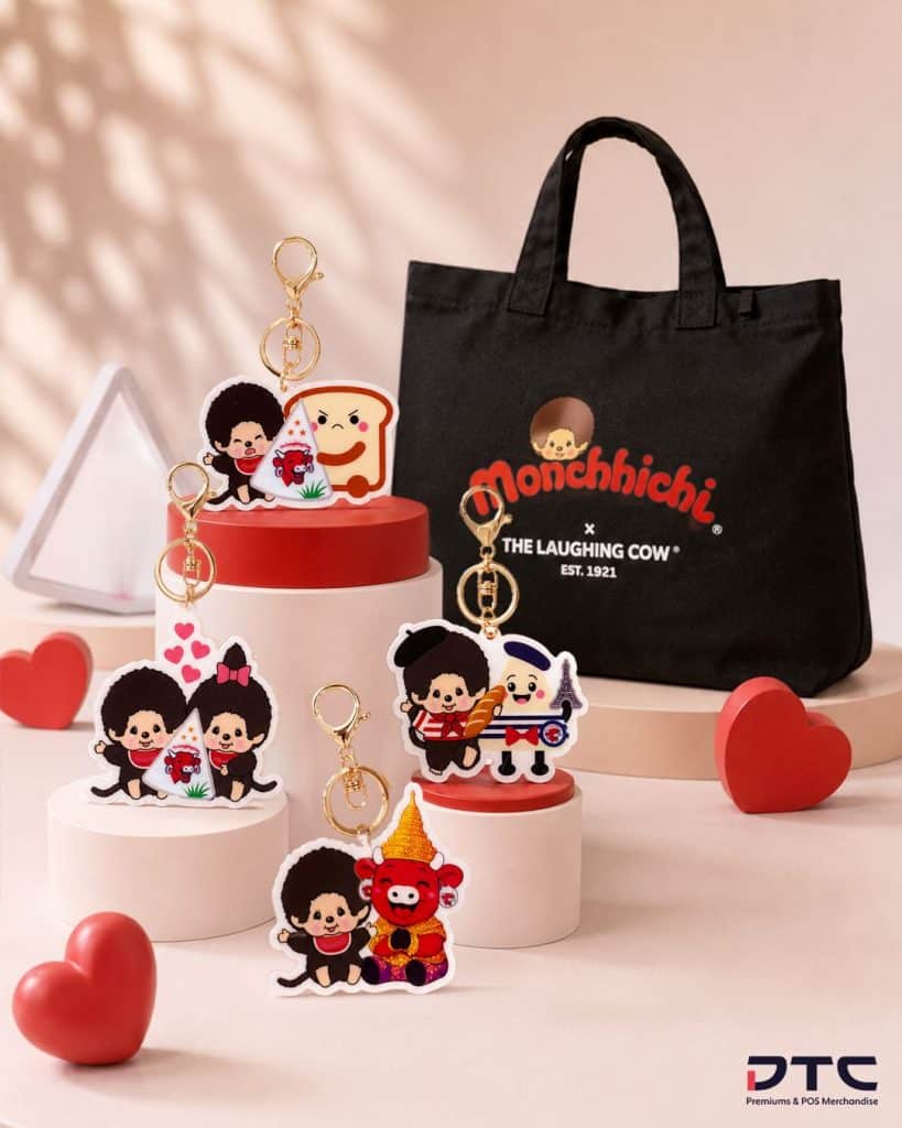 The Laughing Cow × Monchhichi licensed tote bag and collectible keychains produced by DTC World